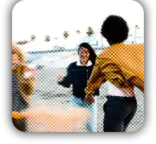Two people laughing together at an outdoor event, viewed through a dreamy filter effect
